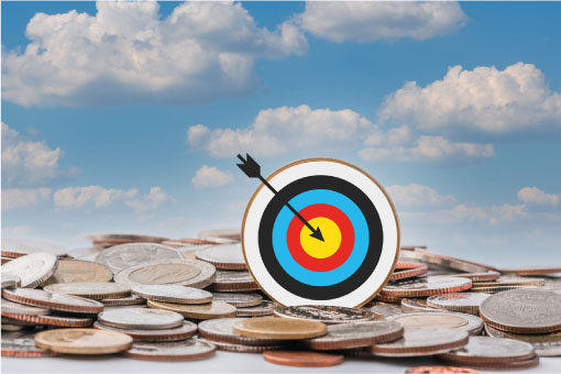 bulls eye with arrow sitting on coins