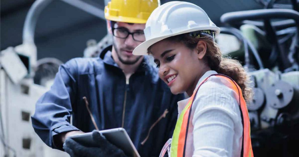 man and woman worker looking at clipboard