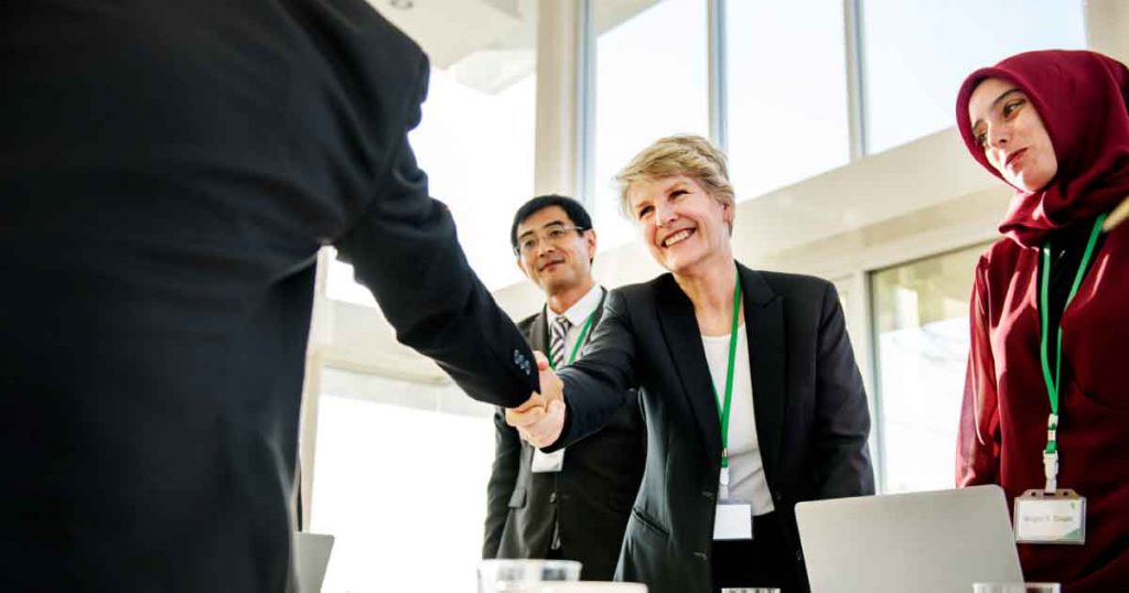 business woman shaking hands in a meeting