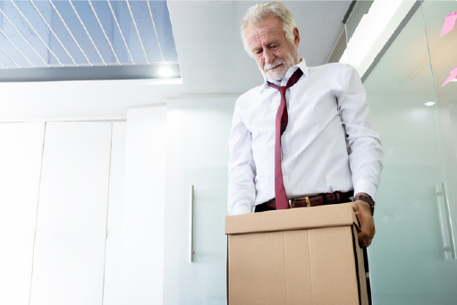 older man carrying box of office supplies
