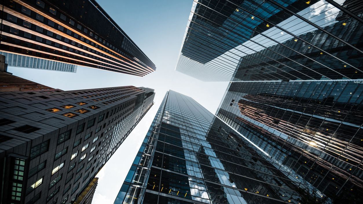 Business and finance concept, looking up at futuristic skyscrapers in the financial district of a modern metropolis.